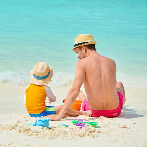 Toddler boy on beach with father Stock Photo