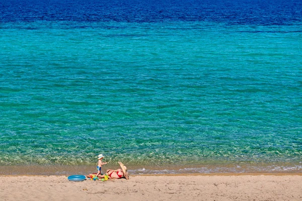 Peuter jongen op strand met moeder — Stockfoto