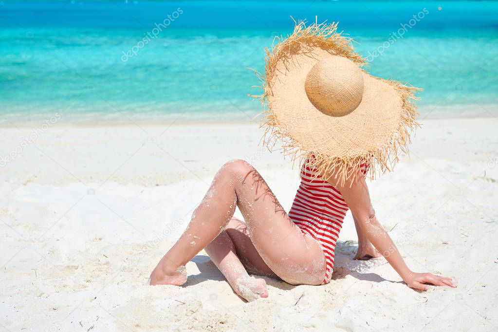 Woman in one-piece swimsuit at beach
