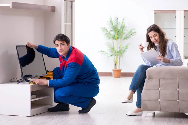 Tv repairman technician repairing tv at home