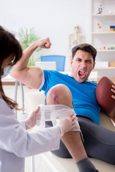 American football player with injury visiting doctor