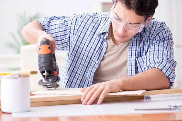 Young man in woodworking hobby concept — Stock Photo, Image