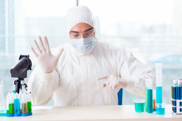 Young chemist pressing virtual buttons in lab — Stock Photo, Image