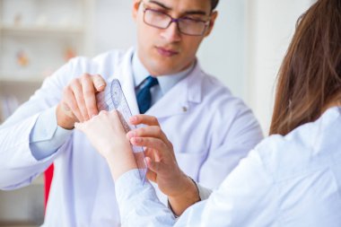 Doktor hastaların eklem esnekliğini gonimetreyle kontrol ediyor.