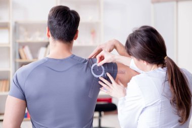 Doktor hastaların eklem esnekliğini gonimetreyle kontrol ediyor.