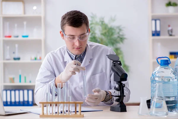 Joven estudiante de química experimentando en laboratorio —  Fotos de Stock