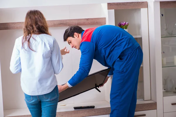 Repairman repairing tv at home