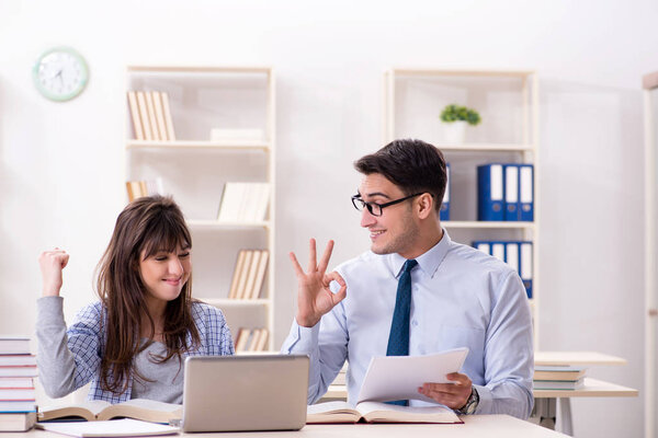 Male lecturer giving lecture to female student
