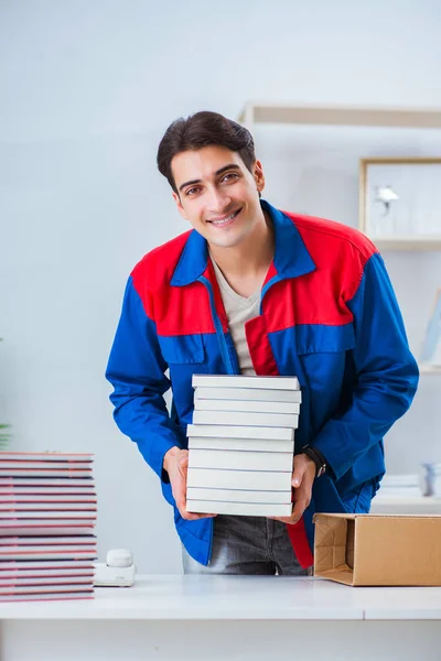 Worker in publishing house preparing book order