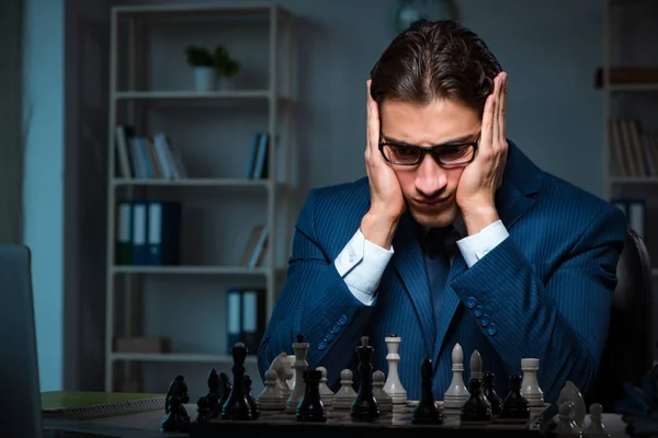 Businessman playing chess in strategy concept — Stock Photo, Image