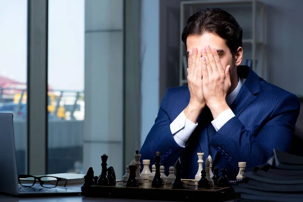 Businessman playing chess in strategy concept — Stock Photo, Image