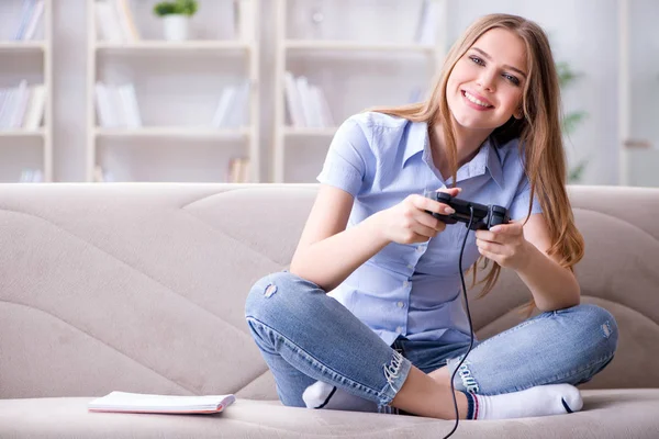 Young female student playing games at home — Stock Photo, Image