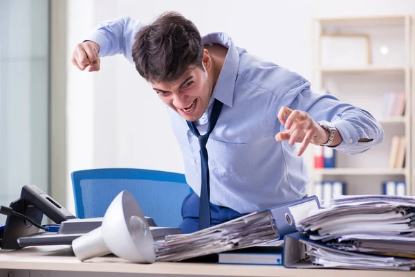 Angry businessman frustrated with too much work