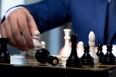İş adamı strateji konseptinde satranç oynuyor