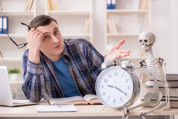 Student and skeleton preparing for school exams — Stock Photo, Image