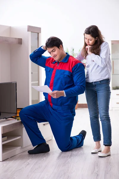 Tv repairman technician repairing tv at home