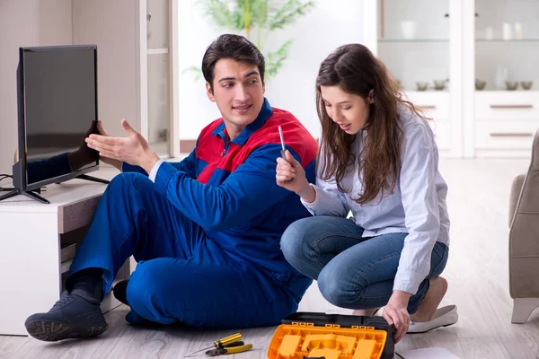 Tv repairman technician repairing tv at home