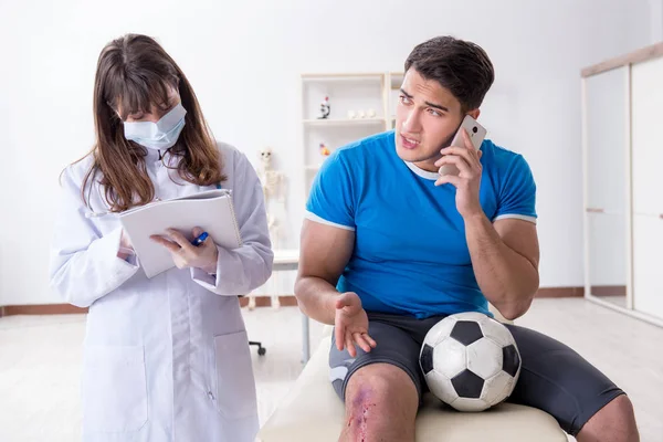 Football soccer player visiting doctor after injury