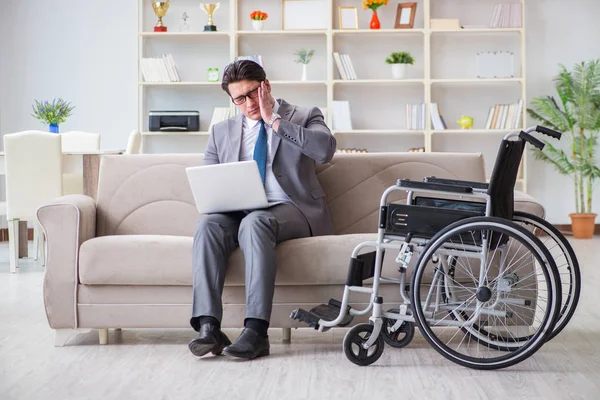 Dsabled businessman on wheelchair working home