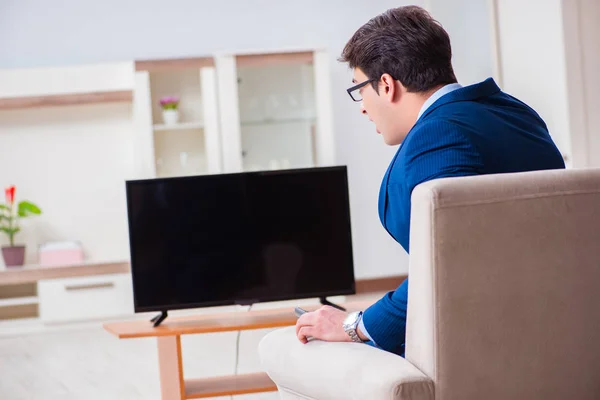 Businesman watching tv in office — Stock Photo, Image