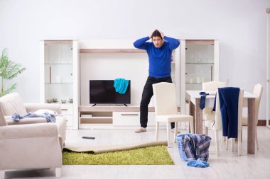 Genç adam çamaşırhane için kirli çamaşır topluyor.