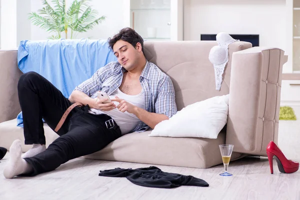 Man with mess at home after house party — Stock Photo, Image