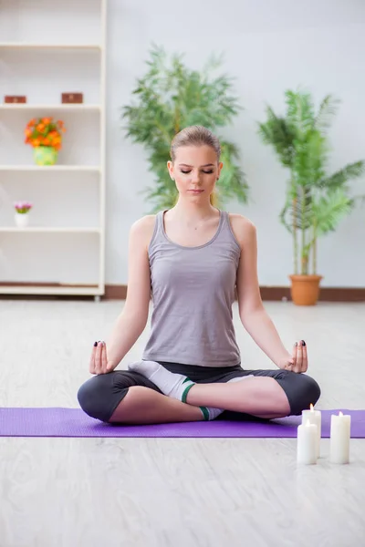 Mladá žena v lotosu pózuje medituje v lázeňské tělocvičně — Stock fotografie