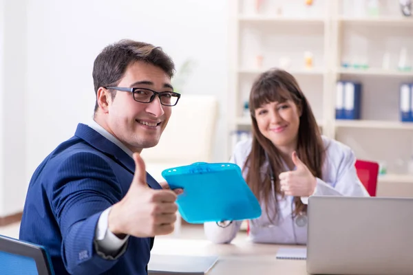 Businessman discussing health issues with doctor