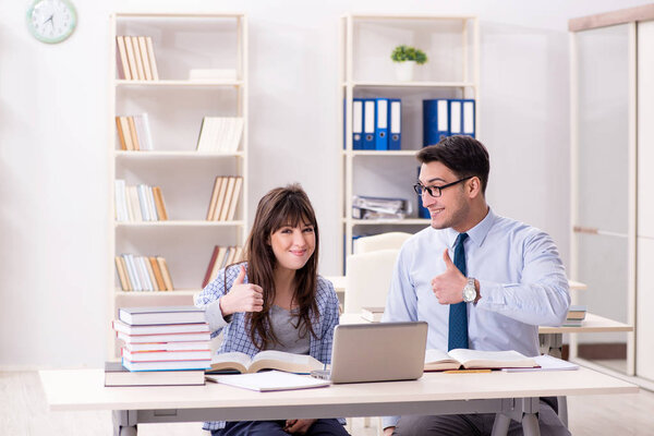 Male lecturer giving lecture to female student