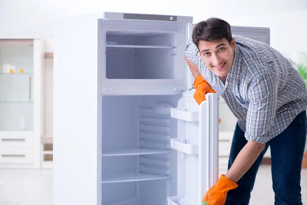 Uomo pulizia frigorifero nel concetto di igiene — Foto Stock