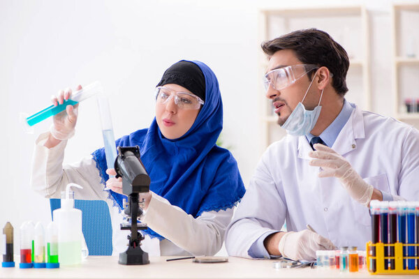 Two chemists working in the lab