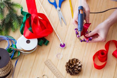 Woman doiing DIY festive decorations at home clipart