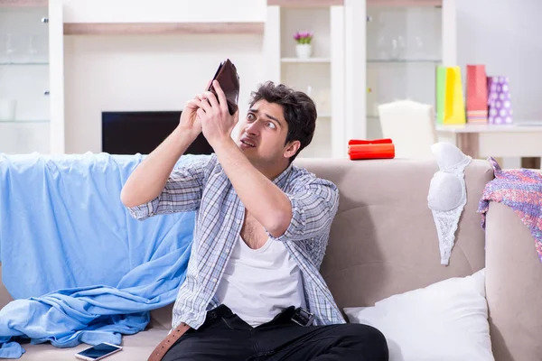 Man with mess at home after house party