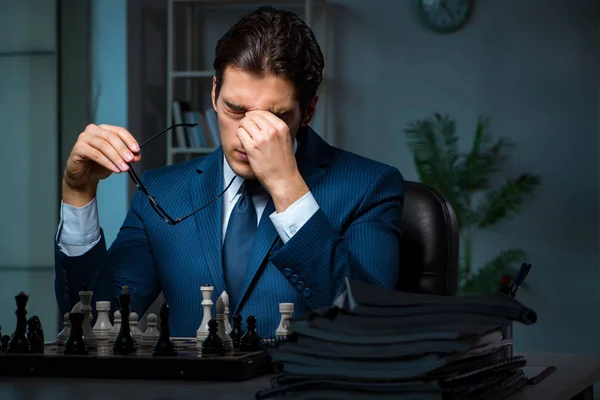 Businessman playing chess in strategy concept — Stock Photo, Image