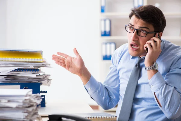 Extremely busy businessman working in office