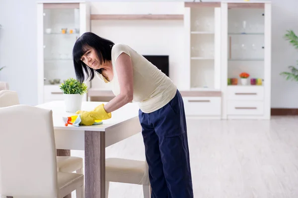 Old mature woman tired after house chores — Stock Photo, Image