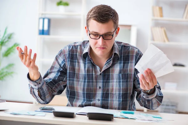 Junger Mann frustriert über sein Haus und Steuerrechnungen — Stockfoto