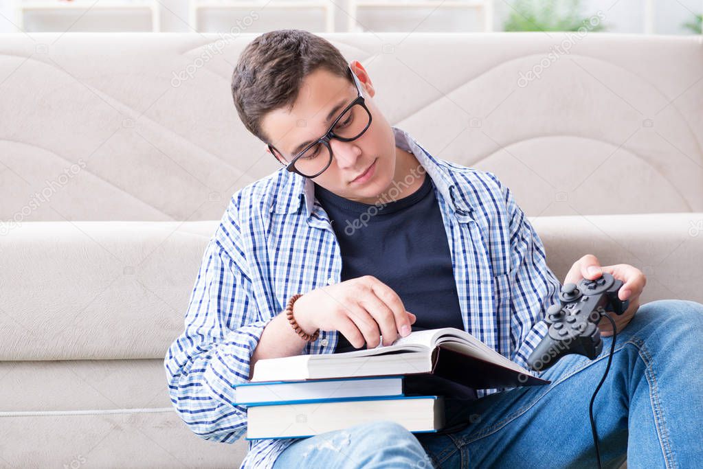 Young student trying to balance studying and playing games