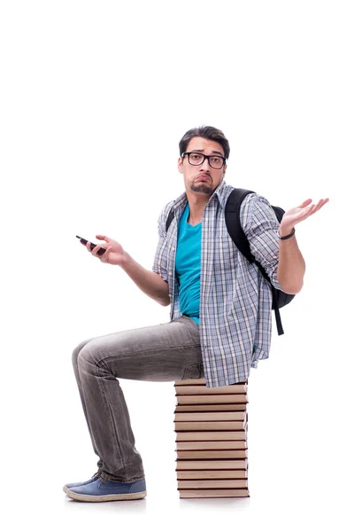 Giovane studente seduto sulla cima di libro pila su bianco — Foto Stock