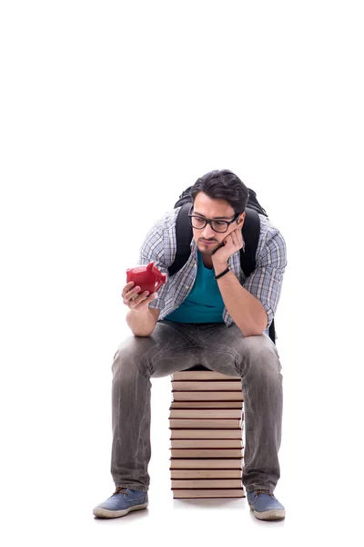 Jonge studente zit op de top van boek stapel op wit — Stockfoto