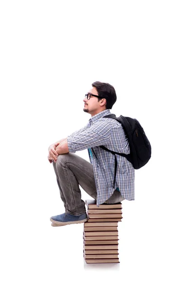 Jonge studente zit op de top van boek stapel op wit — Stockfoto