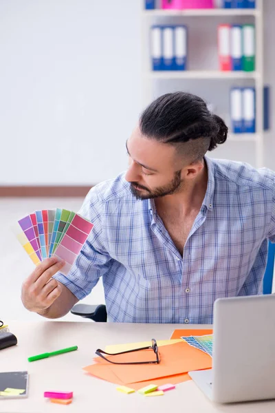 Joven diseñador trabajando en su estudio en un nuevo proyecto — Foto de Stock