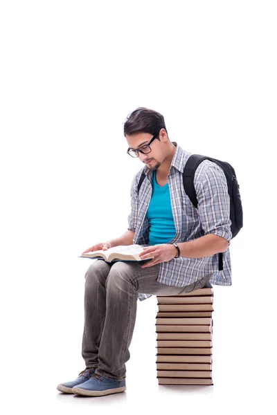 Jovem estudante sentado em cima da pilha de livros em branco — Fotografia de Stock