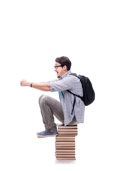 Jovem estudante sentado em cima da pilha de livros em branco — Fotografia de Stock