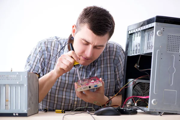 Young technician repairing computer in workshop — Stock Photo, Image