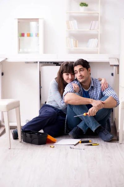 Man and woman assembling furniture at home — Stock Photo, Image