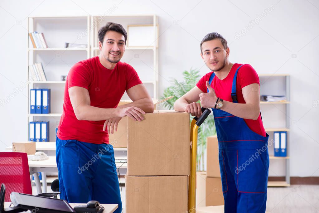 Two contractor employees moving personal belongings
