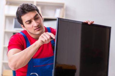 Profesyonel tamir mühendisi bozuk televizyonu tamir ediyor.