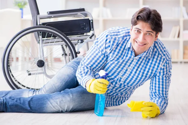 Disabled man on wheelchair cleaning home — Stock Photo, Image