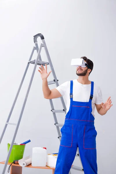VR gözlüklü, duvar kağıdı yapıştıran bir adam. — Stok fotoğraf